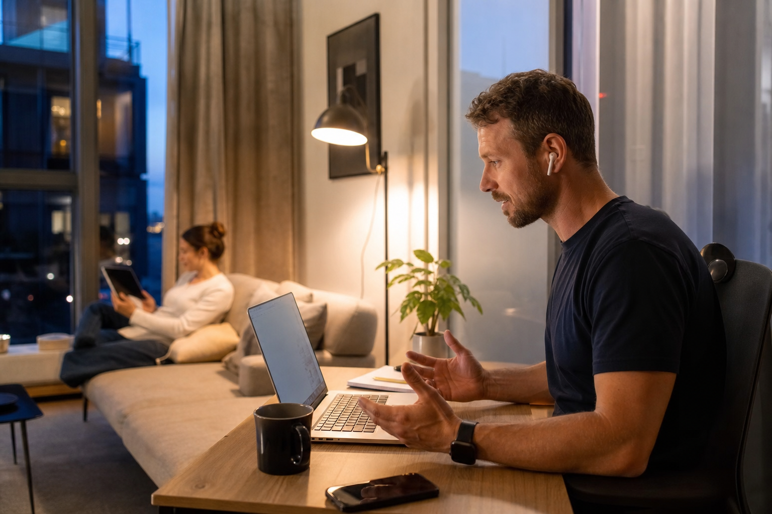 Remote worker checking connection stability during a video call in a shared apartment workspace